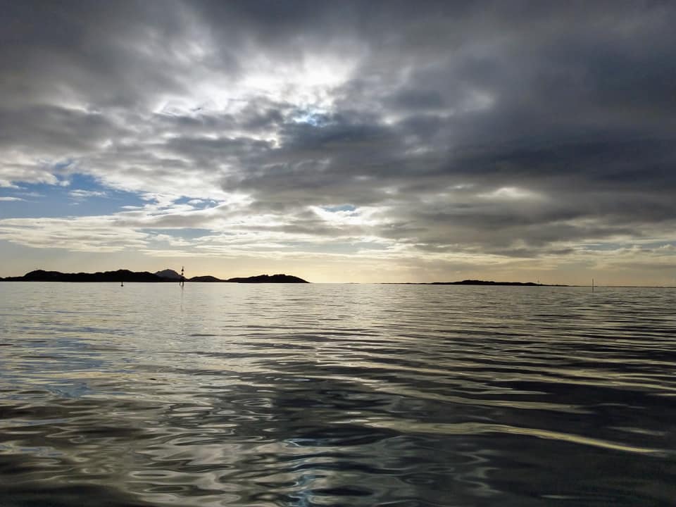 Calm seas with a dramatic sky above.