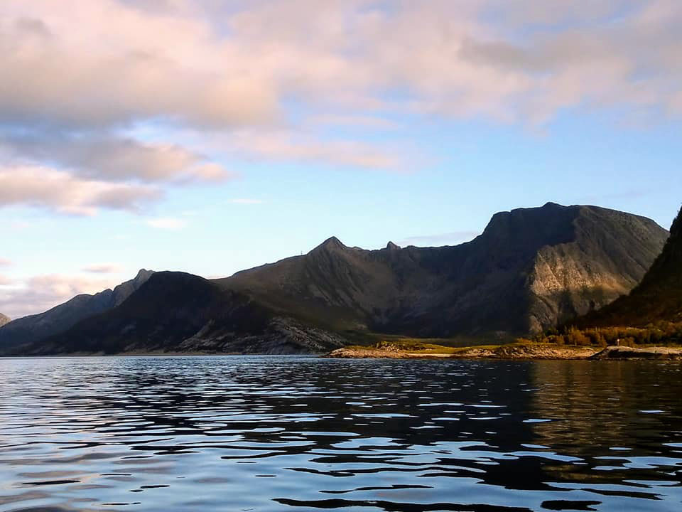 Mountains towering over the calm waters.