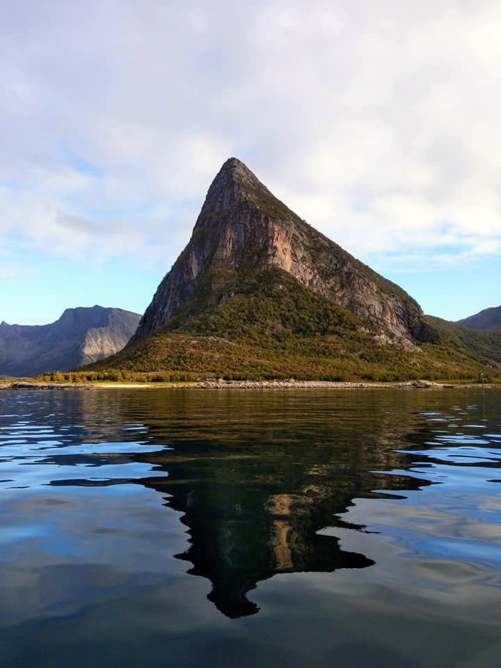 A big, pointed mountain rising out of the water.