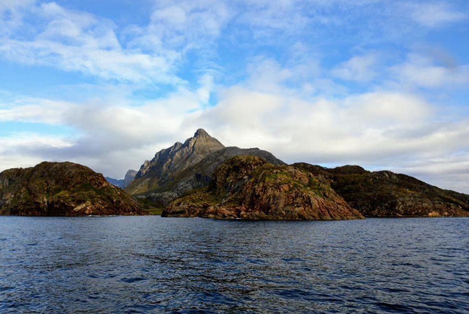 Mountains towering over the calm waters.