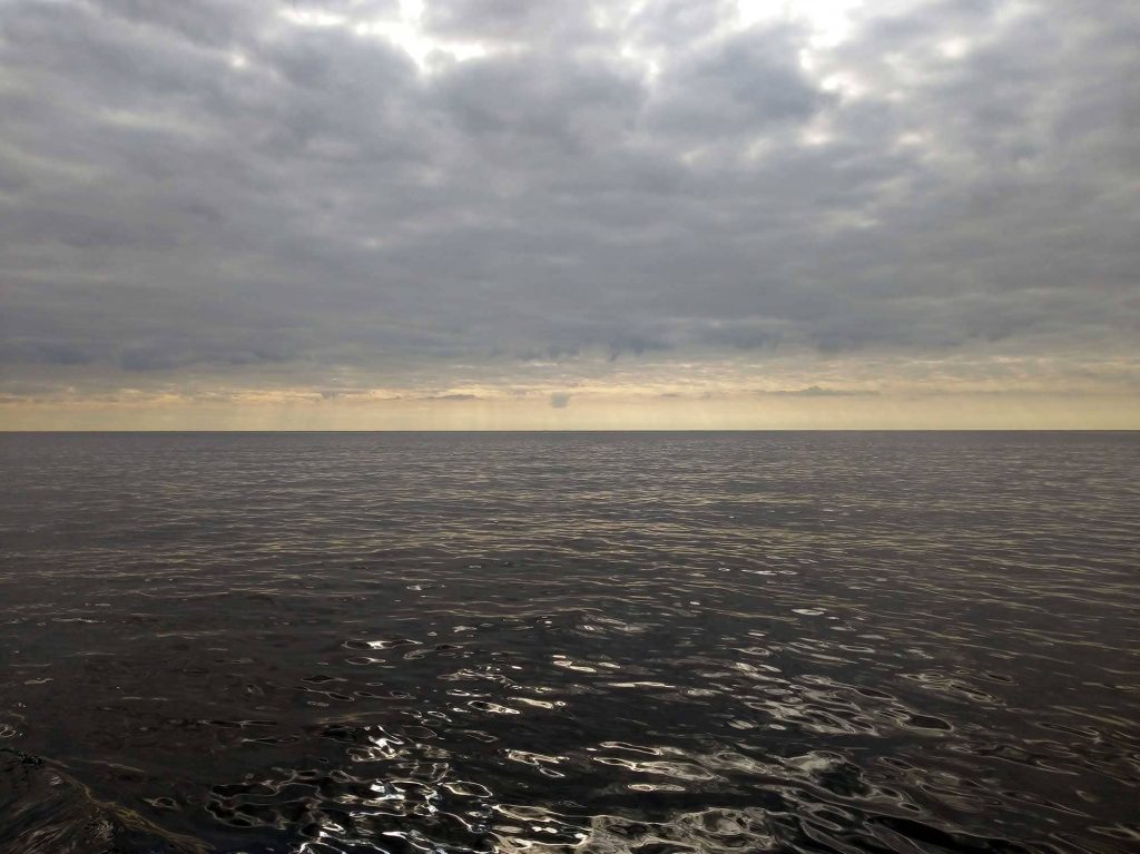 A view of the ocean and sky as far as the eye can see.