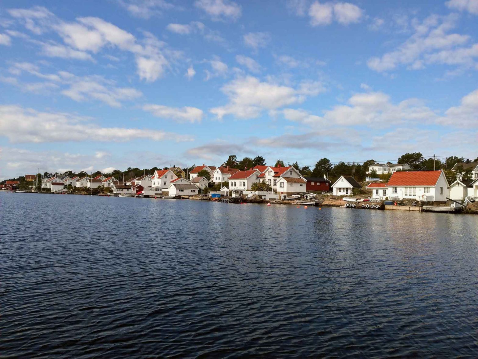 A row of white houses by the water.