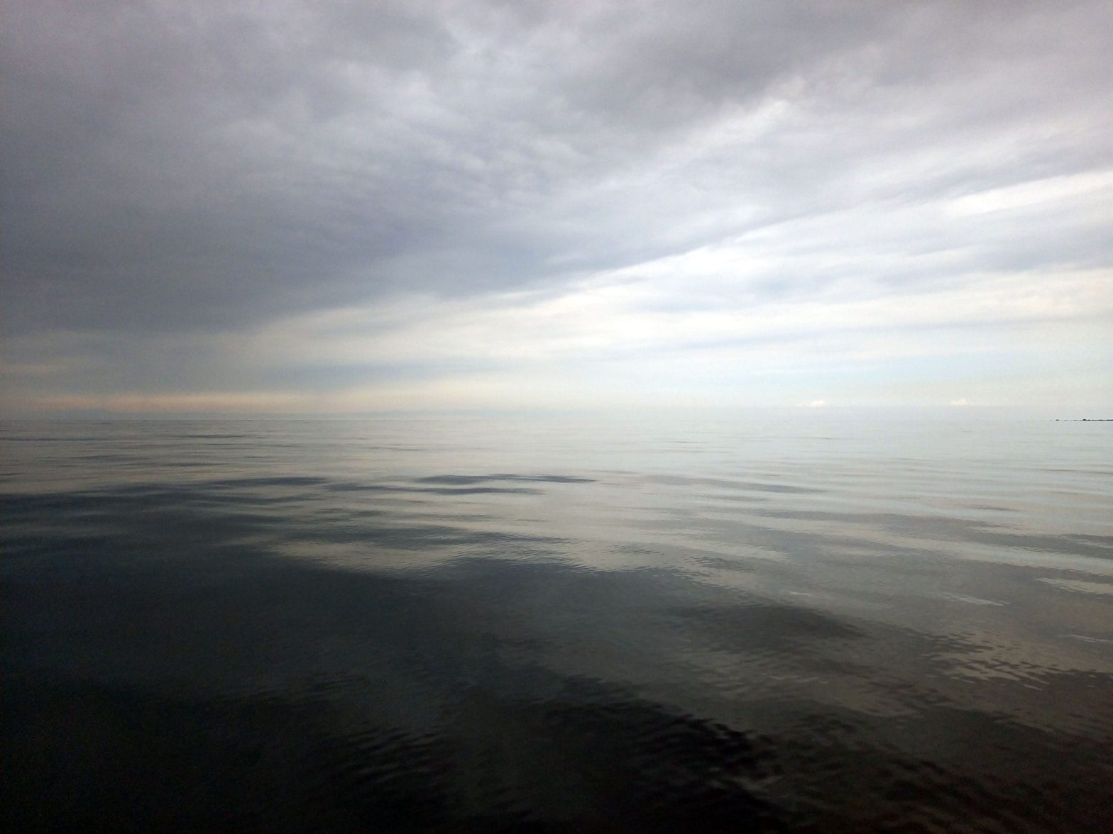 Calm waters blending in with the sky.