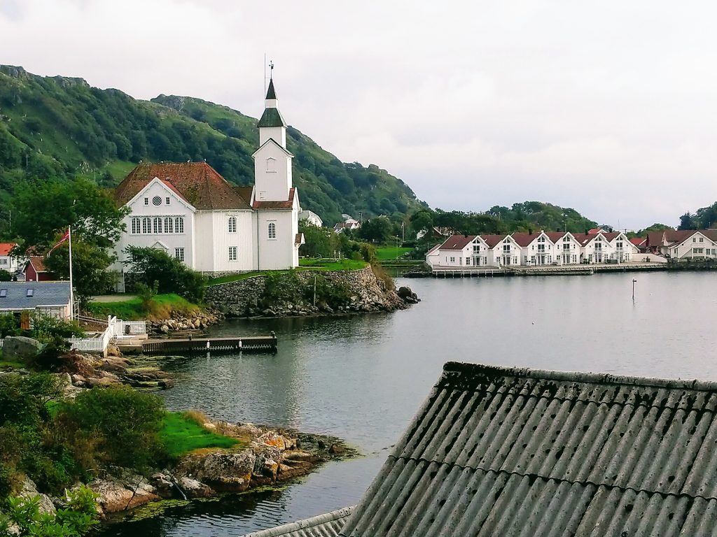 The church of Kirkehamn and some white houses along the water.