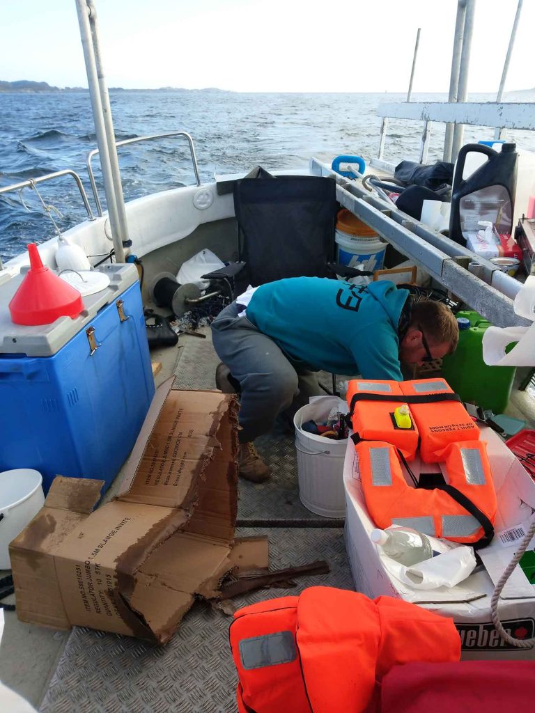 V crouched over in a huge mess on the deck of the boat.