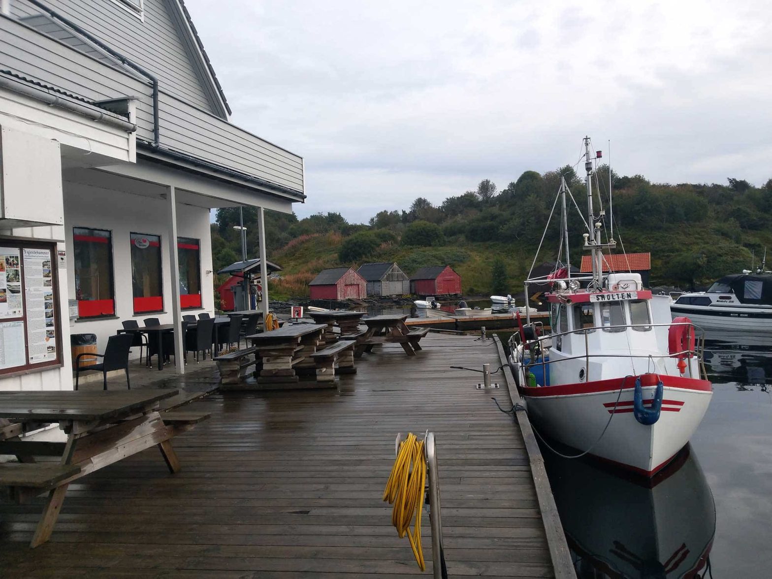 Smolten docked with a cafe and some picnic tables on the left.