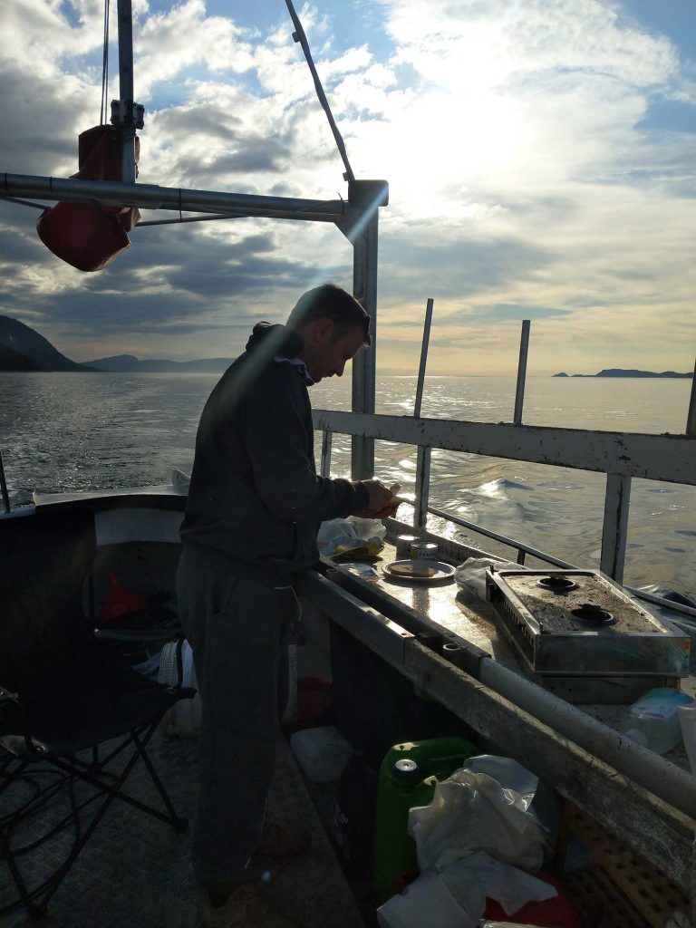 V cooking dinner on the deck of Smolten. 