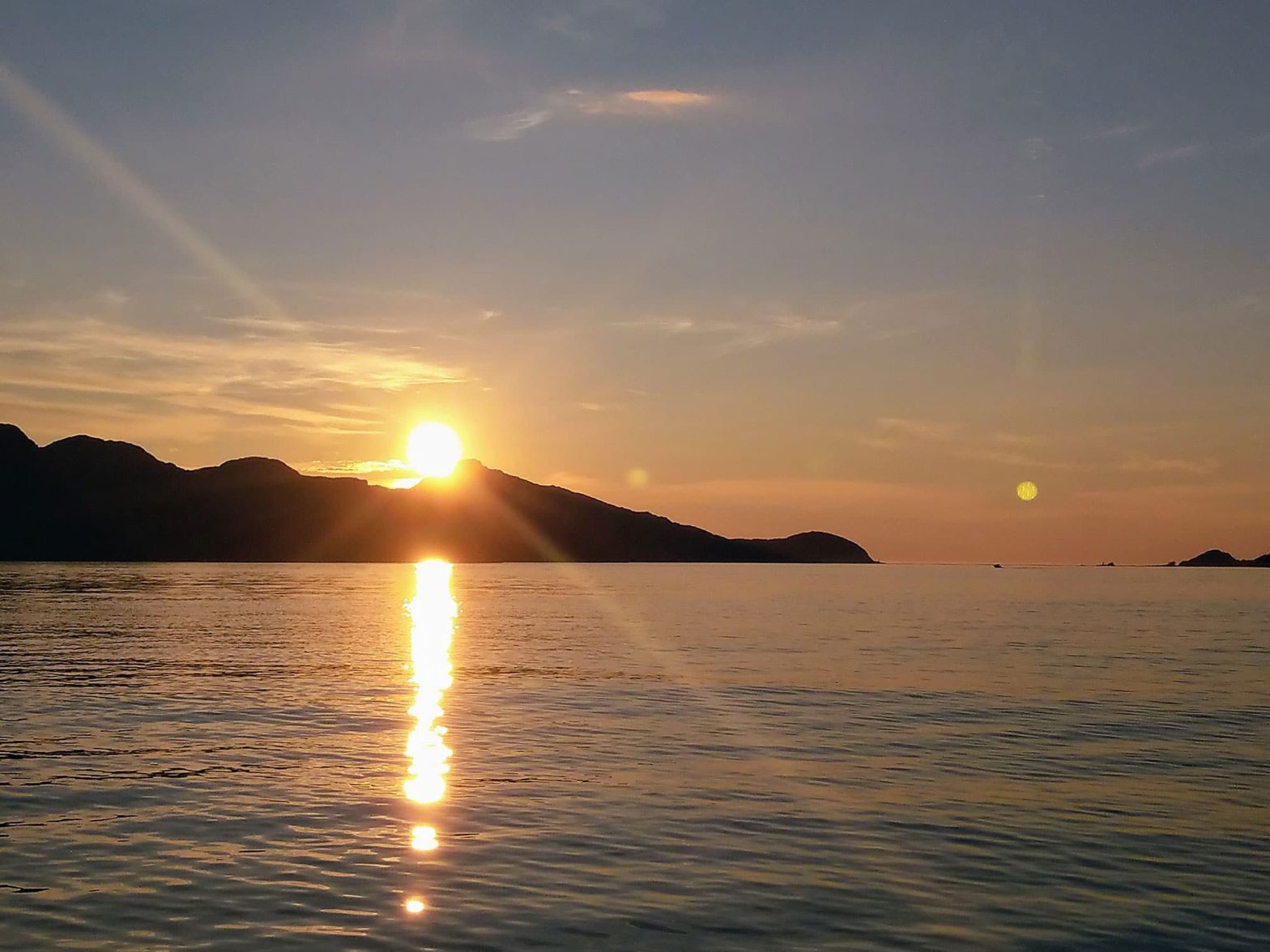 Sunset over a mountain and the sea.