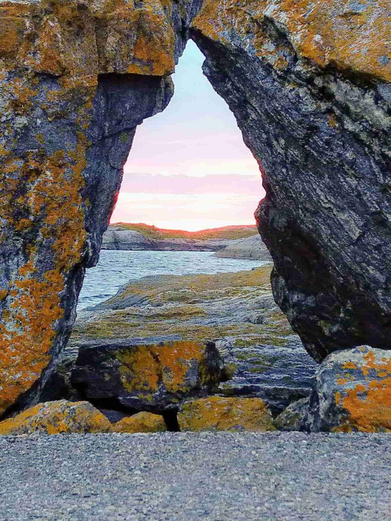 Two rocks leaned against each other  creating a triangle you can look through. 