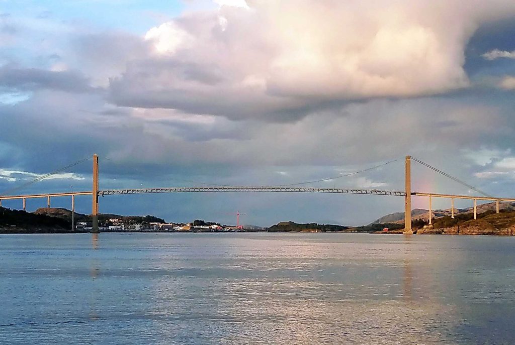 A long, tall bridge over a fjord.