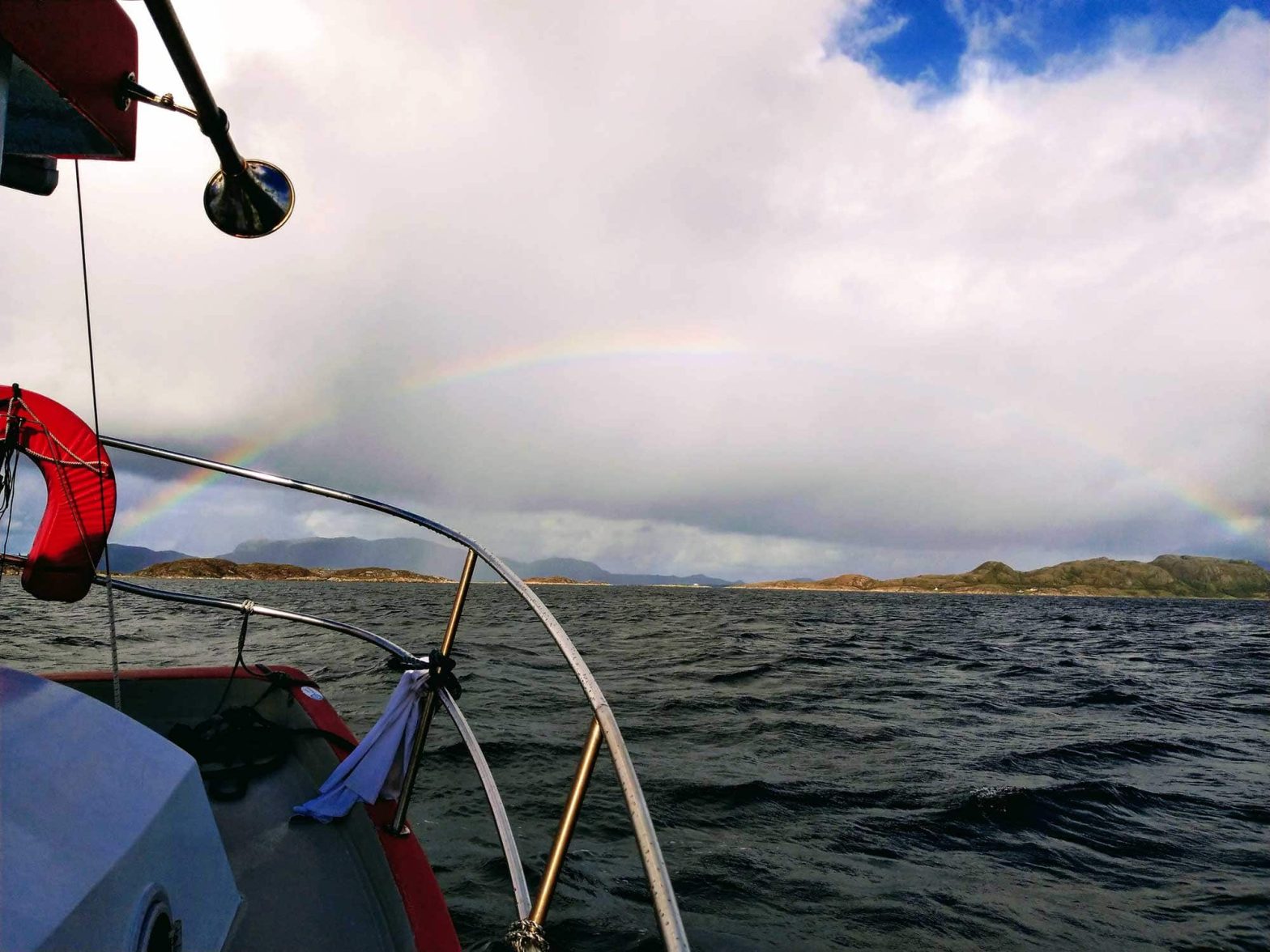 A full rainbow in the distance from the deck on Smolten.